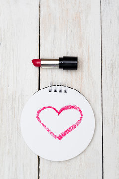 Valentine vertical. Heart painted red lipstick on paper.