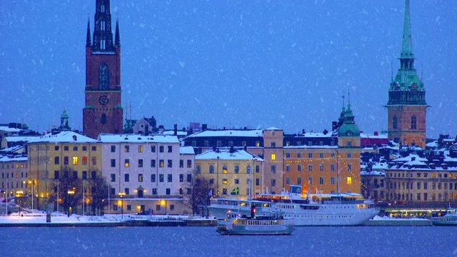 A public ferry for commuters crossing the waters on a snowy and wintry evening in Stockholm