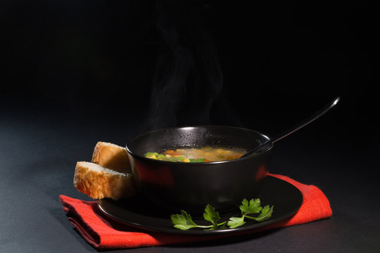 Vegetable soup in a black plate