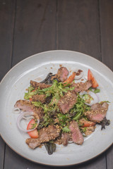 Close up Roasted beef with herbed bread crust sliced and vegetable. (selective focus)