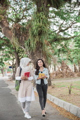 Fototapeta na wymiar two asian student walking on campus