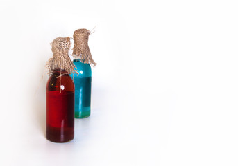 Two bottles of bright liquid isolated close-up
