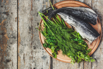 raw fish and greens on the kitchenette (headless)