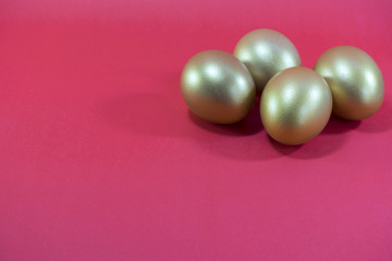 Golden eggs in concept investment or Easter on red background