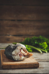 raw fish and greens on the kitchenette (headless)