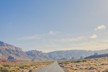 empty highway road in desert valley landscape -  mountain background