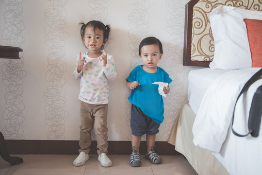 toddler standing against the wall