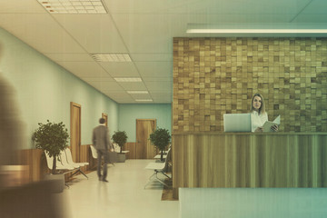 Blue and wooden reception desk, people