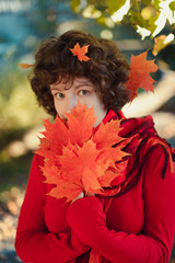 Curly girl in the autumn forest.