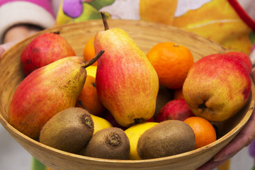 hands with fruit bowl full of fruits