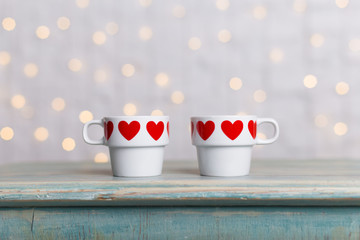 two valentines day cups with red hearts