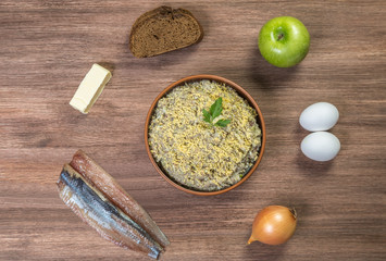      Forshmak in a bowl with the ingredients. National Jewish dish. The view from the top.