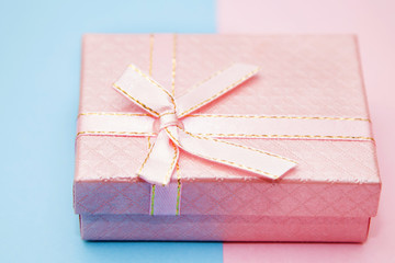 gift box on blue and pink background
