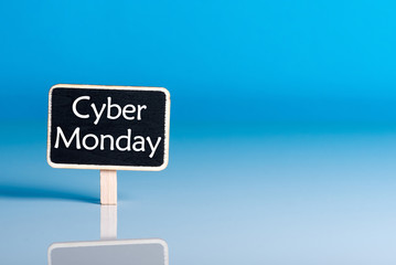 Cyber Monday shopping sale concept with little wooden tag. Sale tag close up on blue background. Best Online shopping time. Day with biggest Sale. Mockup