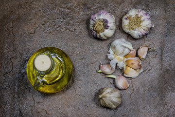 garlic and spices on a stone table in the kitchen. Healthy and fragrant cloves of garlic. Stone table.