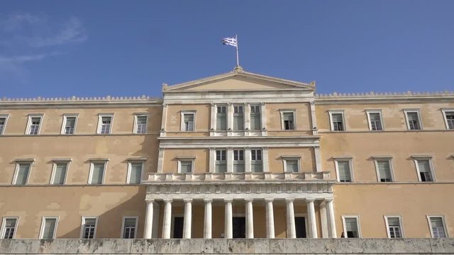 waving flag on the Greek parliament building in Athens, Greece