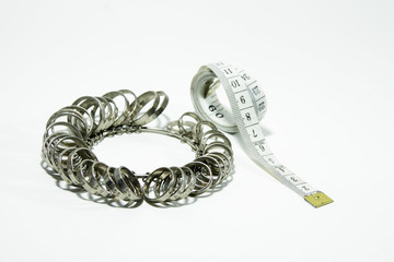 The ring size is made steel and measuring tape on white background