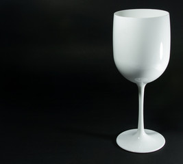 A glass of white wine on isolated black