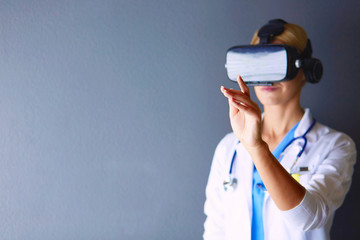 Female doctor wearing virtual reality glasses isolated on white background