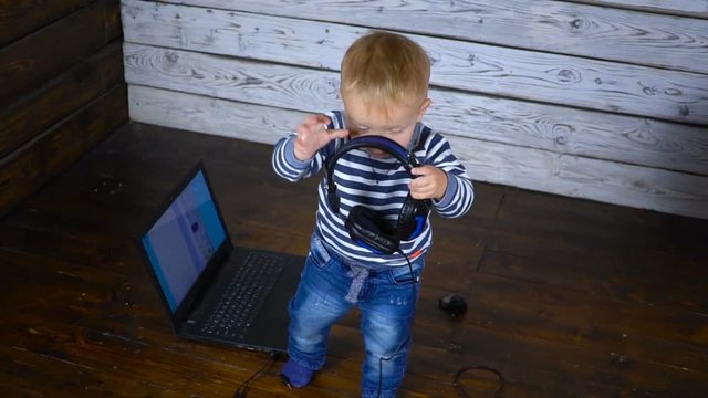 beautiful one year old child is played with a laptop. business comcept
