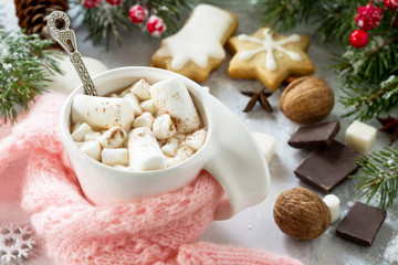 Christmas background frame or greeting xmas card. Christmas table decor and a cup of hot chocolate with a warm scarf.