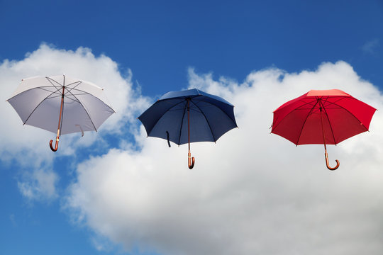 Floating Umbrellas in White, Dark Blue and Red