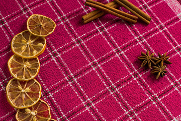 Lemon, cinnamon, anise on a pink background