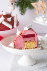 French raspberry mousse cake with pink mirror glaze.