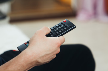 the TV remote in hand