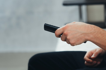 the TV remote in hand