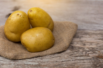 Potato put on wooden floor.