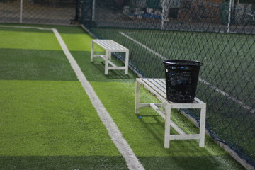 Artificial turf football field with chair indoor sport