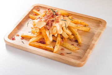 French Fried Melted Cheddar Cheese with Crispy Bacon and Rosemary on Wooden Plate, White...