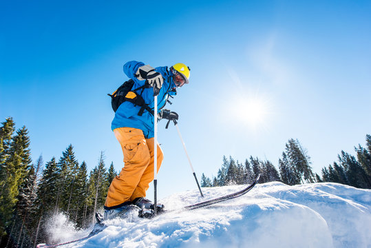 Low angle shot of a skier riding down the slope at ski resort mountains copyspace seasonal activity sport sportsman hobby recreation travel concept