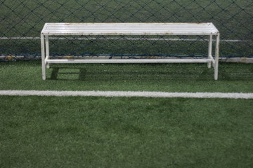 white bench,Long chair on the artificial grass football field