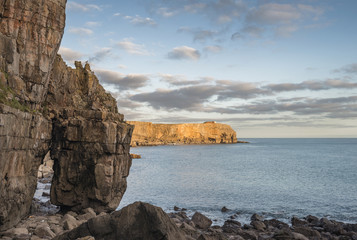Fototapeta na wymiar Stunning vibrant landscape image of cliffs around St Govan's Head on Pembrokeshire Coast in Wales