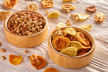 Dried fruits and nuts on wooden background