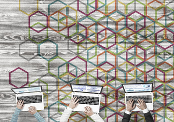 Top view of businesspeople sitting at table and using gadgets