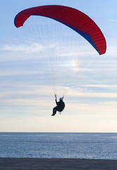 Paraglider flying at sunset over Blue lagoon in Oludeniz, Turkey