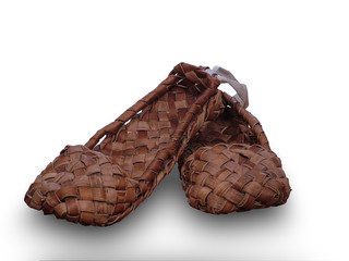 Old russian shoes from birch bark, bast shoes isolated on white background