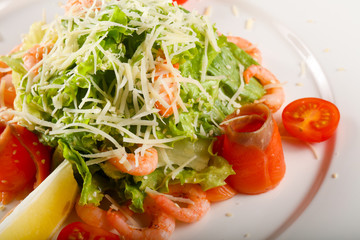 Caesar salad with shrimps and salmon