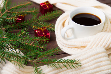 Christmas coffee with a warm scarf and Christmas decorations