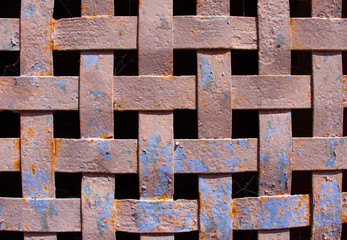 Iron rusty lattice window of a medieval house.