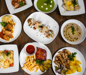 dishes with different food on the wooden table. top view
