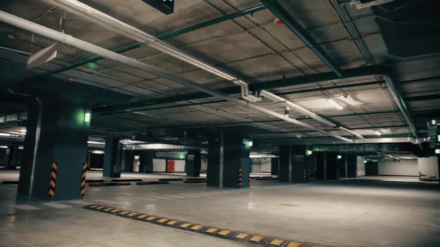 New modern empty underground parking garage for cars, auto park interior inside, toned footage 