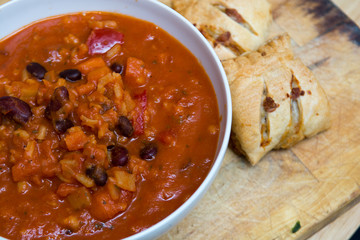 Warming bean and rice soup in a bowl with bread