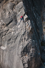 The girl climbs the rock.
