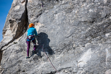 The girl climbs the rock.