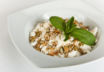 plate of homemade curd with pumpkin seeds