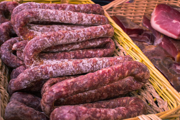 Sausages and ham from dried pork meat in a basketl.